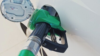 Gas Station Fuel Gasoline Pump Nozzle Pistol Inserted into Car Tank Filler Hatch Parallax