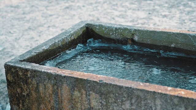 Thin Ice on Surface of Frozen Water Left Outdoor Concrete Stone Trough Channel on Cold Winter Day