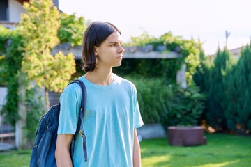 Fototapeta premium Portrait of teenage guy 18, 19 years old in profile, outdoor copy space