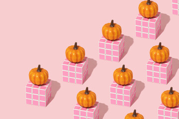 Autumn creative pattern made with pumpkin on pink cube on pastel baby pink background. Vintage retro aesthetic 80s or 90s fashion fruit concept. Minimal autumn season food idea.
