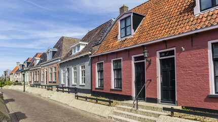 Fototapeta na wymiar Colorful traditional houses in the small village Holwerd, Netherlands, Netherlands