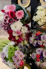Closeup of bouquet of flowers placed next to Buckingham Palace
