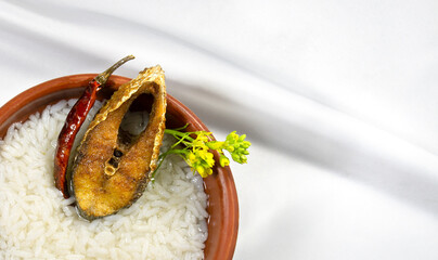 ilish panta Bengali new year festive dish. Boishakh panta ilish with green chilli and onion. Panta bhat is popular among Bengali's in India and Bangladesh. into clay plate seving bowl shanki or sanki - obrazy, fototapety, plakaty