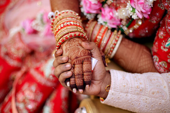 Henna Hands of a beautiful Bride during Indian Wedding Ritual.