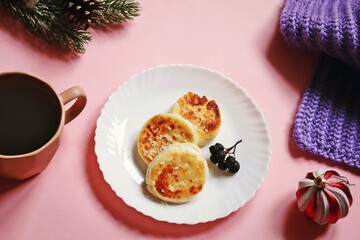 Fluffy cottage cheese pancakes on a plate and coffee cup. Winter breakfast still life food photography