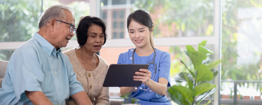 Panoramic asian nurse work in nursing home with digital tablet consults service to patient explains health care symptoms and help elderly people, Concept of elderly care, health care and insurance.
