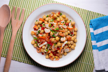 Chickpea salad with crab and vegetables. Cold salad typical Spanish cuisine.