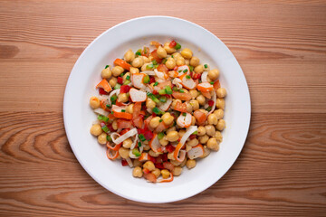 Chickpea salad with crab and vegetables. Cold salad typical Spanish cuisine.