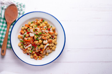 Chickpea salad with crab and vegetables. Cold salad typical Spanish cuisine.