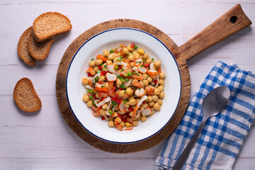 Chickpea salad with crab and vegetables. Cold salad typical Spanish cuisine.
