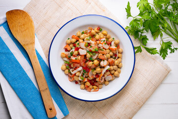 Chickpea salad with crab and vegetables. Cold salad typical Spanish cuisine.