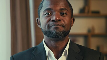 Portrait confident african american man businessman looking at camera nodding head answering yes giving positive answer nods in agreement posing indoors demonstrates approval support agree acclaim