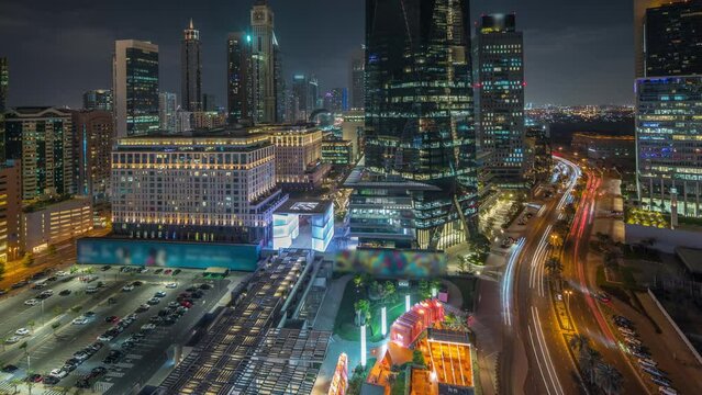 Panorama showing Dubai International Financial district aerial night timelapse. View of business and financial office towers.