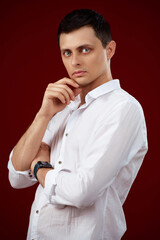 man holding arms folded, touching chin with hand