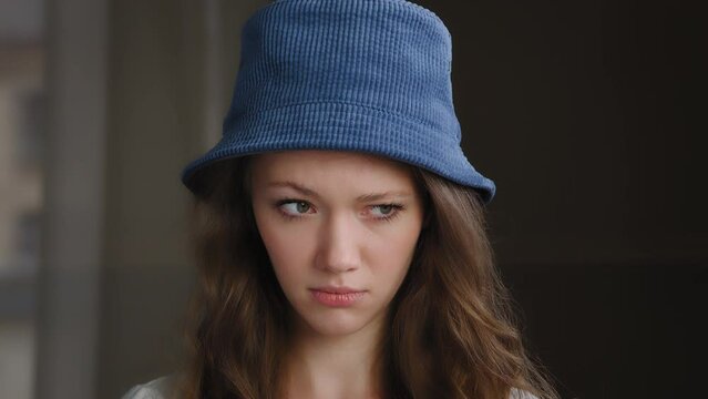 Close-up sad offended female face upset frustrated teenage girl with resentful expression feel embarrassed anxiety anxiety anxious distressed young caucasian woman worries about bad news stands indoor