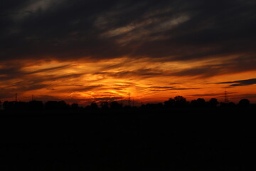 Obraz premium Beautiful sunset with orange and yellow clouds