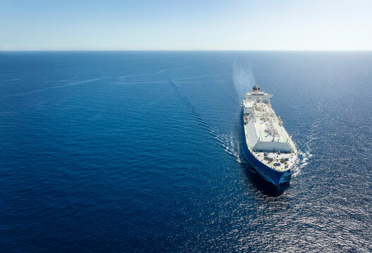 High Aerial View Of A Large LNG Or Liquid Gas Tanker Ship Traveling Over Blue Ocean, With Copy Space