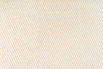 Fototapeta na wymiar Texture of natural fabric or cloth. Fabric texture diagonal weave of natural cotton or linen textile material. Beige canvas background. Decorative fabric for curtain, furniture, walls, clothes