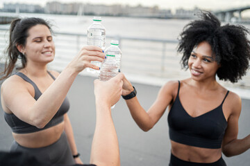 Drinking water break friends sportswear. The concept of sports people in the city runners.