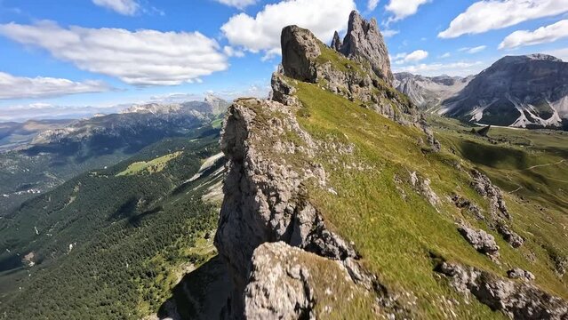 Seceda peak Italy. Dolomites Alps, South Tyrol in Italy, Europe. Odle mountain range, Val Gardena, Trentino Alto Adige. FPV fast race drone mountain surfing. Majestic Furchetta peak.