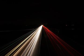 Fototapeta na wymiar Red and white car light stripes on a street