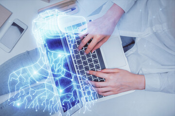 Double exposure of woman hands working on computer and man in ar glasses hologram drawing. Top...