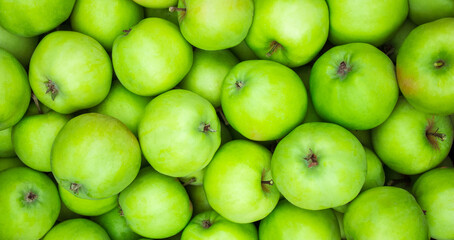 Green apples background. Lots of homemade natural apples. Healthy organic fresh food. Proper nutrition and vitamins.