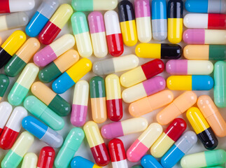 Colorful pill capsule on white background.