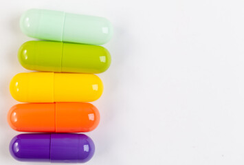 Colorful pill capsule on white background.