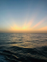 Naklejka premium View from the bridge wings of a container ship at sea in the golden hour after sunset