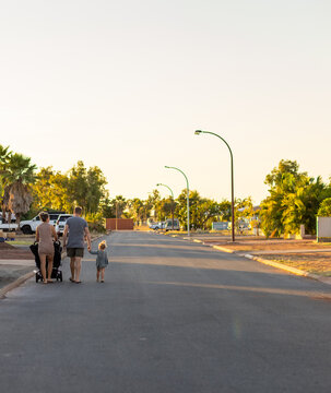 Young Family From Behind On Suburban Street In Karratha