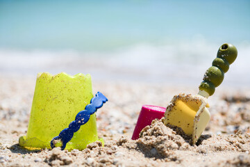 Sand bucket and scoop toys at beach