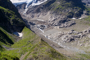 Glacier river of Stone Glacier at region of Swiss mountain pass Sustenpass in the Swiss Alps on a sunny summer day. Photo taken July 13th, 2022, Susten Pass, Switzerland.
