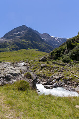 Fototapeta na wymiar Beautiful scenic view of Stone Glacier at Swiss mountain pass Sustenpass with glacier river in the foreground on a sunny summer day. Photo taken July 13th, 2022, Susten Pass, Switzerland.