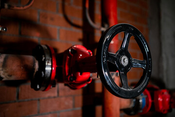 Pipes and valves with red knobs for hot water
