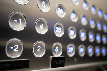 Closeup of metal buttons in an elevator background