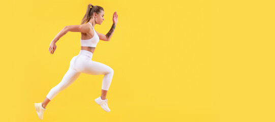 Fototapeta na wymiar fitness woman runner running on yellow background. copy space. Woman jumping running banner with mock up copyspace.