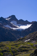 Obraz premium Beautiful scenic view of mountain panorama with Tschingelfirn Glacier at Swiss mountain pass Susten on a sunny summer day. Photo taken July 13th, 2022, Susten Pass, Switzerland.