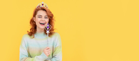 happy redhead woman in queen crown with magic wand, dreams come true. Woman isolated face portrait,...