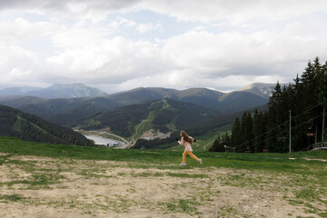 Tourist young girl child on the top of the Carpathian mountains Ukraine Bukovel. Vacation concept...