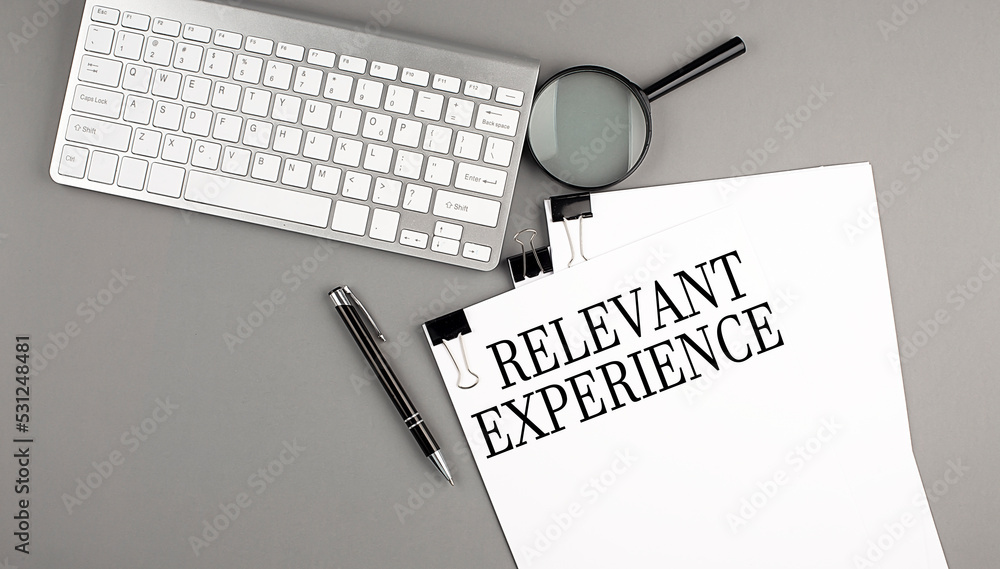 Poster relevant experience text on paper with keyboard, magnifier and pen. business concept
