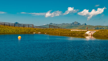 Beautiful alpine summer view with reflections in a lake at the famous Schattberg mountain, Saalbach-Hinterglemm, Salzburg, Austria