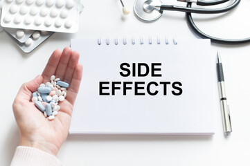 On the tablet for writing the text Side Effects, next to the stethoscope and white tablets.