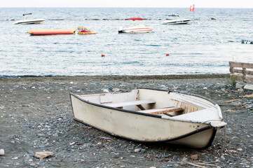 A Lonely Old Fishing Boat Is Pulled Out On The Seashore.