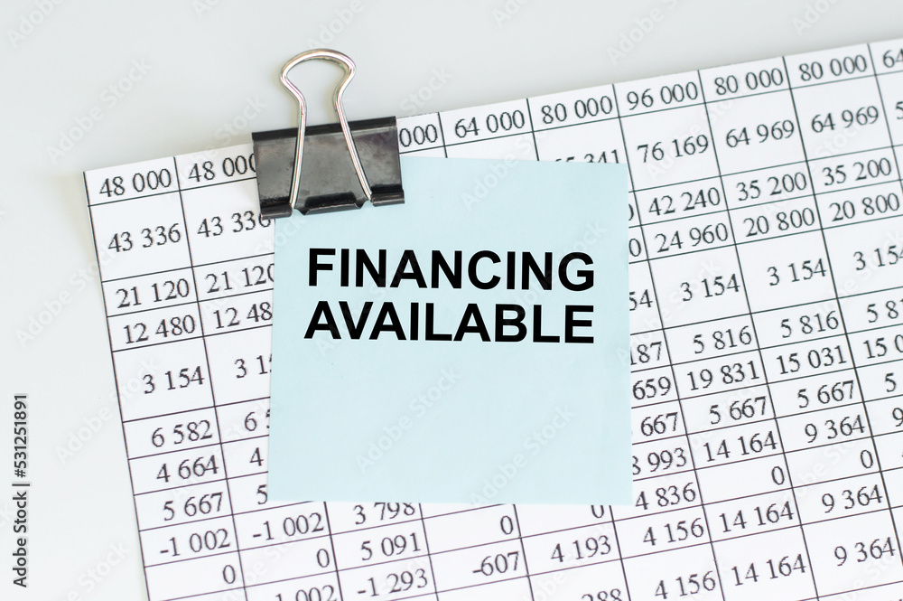 Poster financing available text on a card clip to a sheet with numbers on the table, business concept