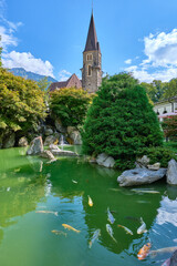 small japanese lake with carps near the cathedral of interlaken, switzerland
