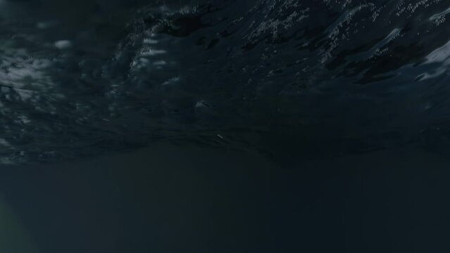 View of the lighthouse from the surface of the stormy ocean. The camera sways along with the big ocean waves. So sees a man floating in the water in a storm.