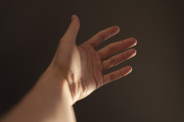 Naklejka premium Man hand plays with natural sun light