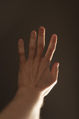 Man hand plays with natural sun light