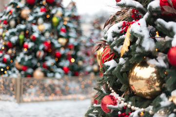 Christmas and New Year time, amazing Xmas decorations on pine trees with real snow, blurred...